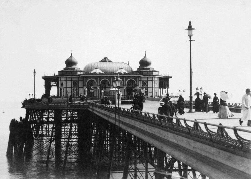 Victorian photograph of people walking on the pier, pavilion in the background
